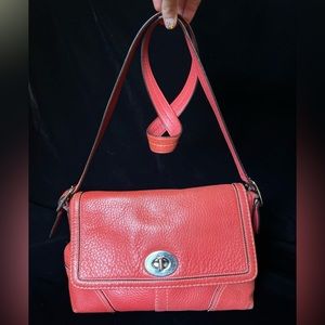 Coral coach crossbody purse made of pebbled leather
